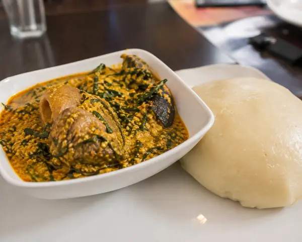 Bowl of Nigerian egusi soup served with pounded yam